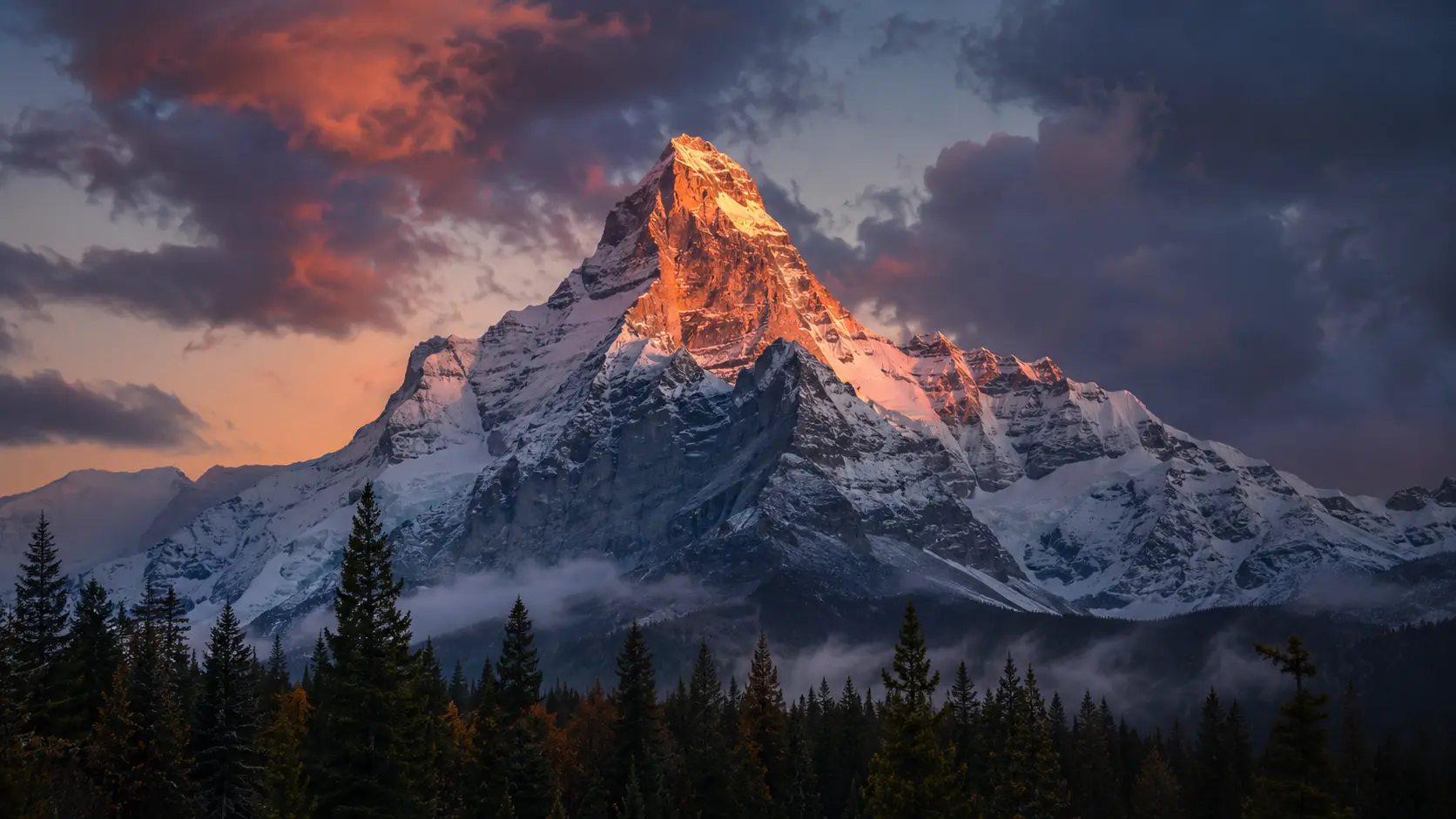 Last alpenglow on a snow-dusted summit at dusk